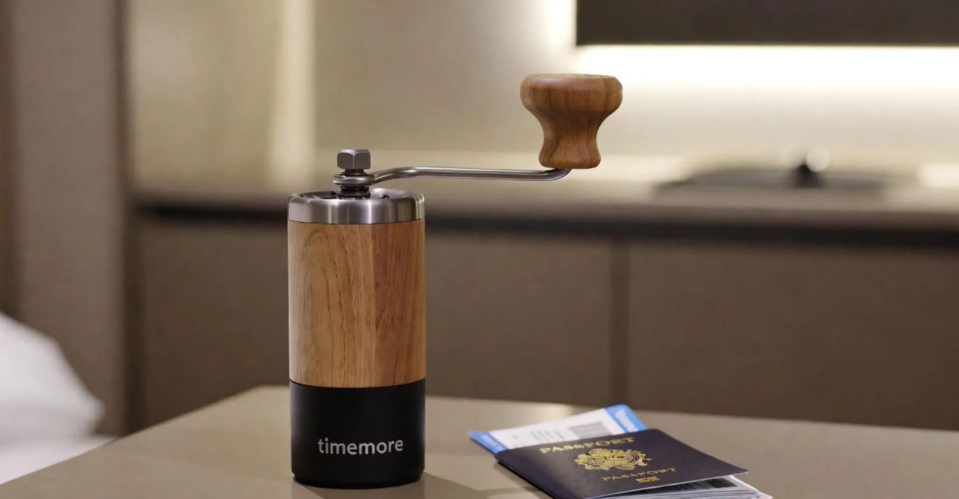 Timemore Chestnut C3 Pro manual grinder with its foldable handle, highlighting its compact travel design.