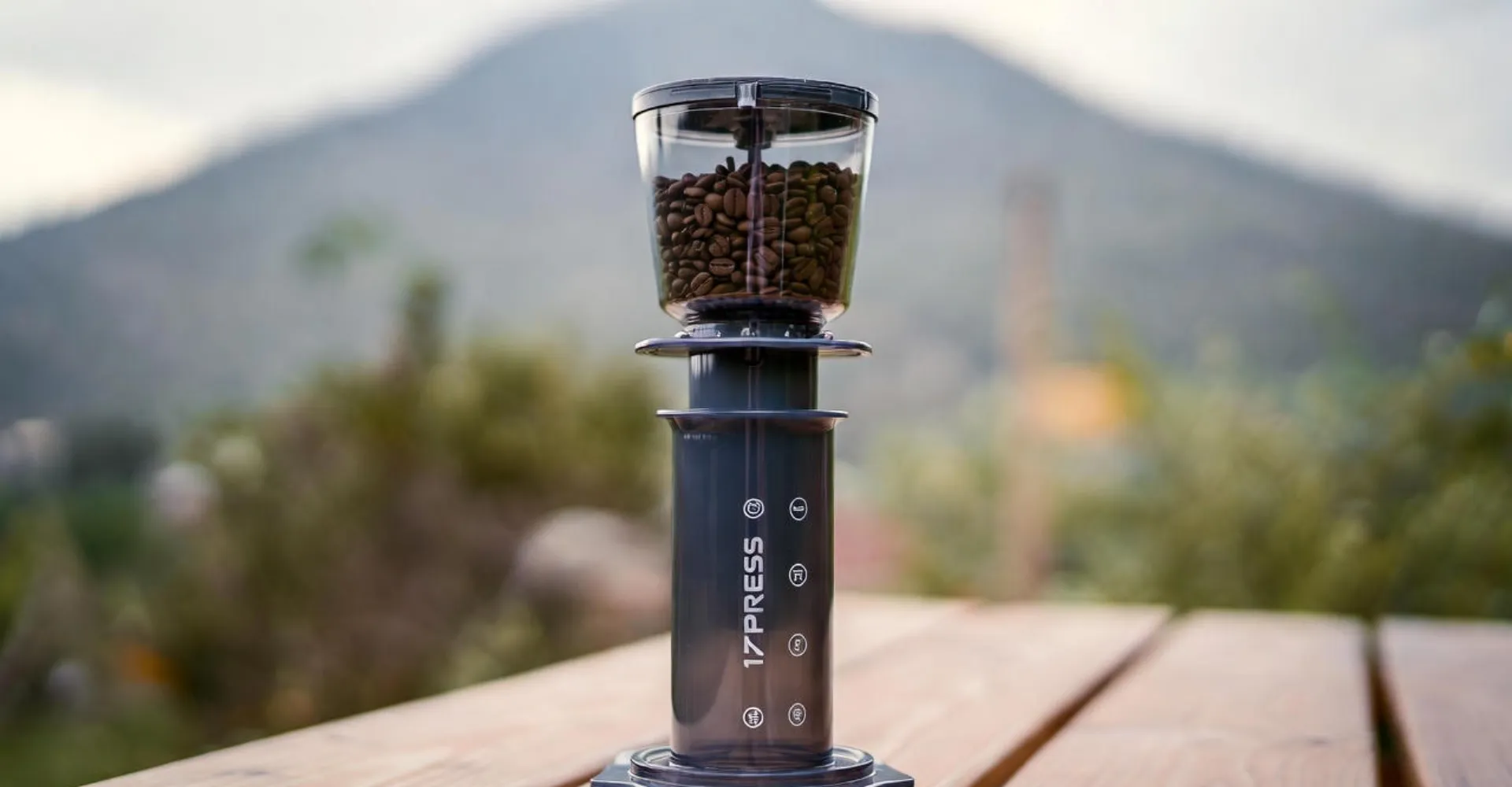 The 1Zpresso Q Air manual grinder fitting perfectly inside an AeroPress for compact travel.